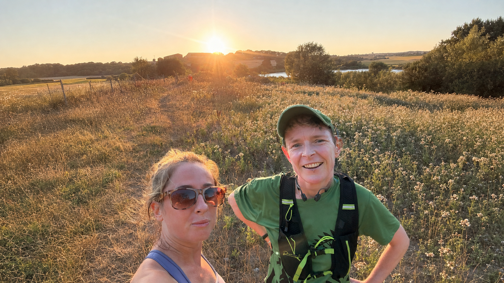 Hopkins, wearing blue on the left, and Dr Strings, wearing a green T-shirt and cap on the right, outdoors together at sunset.